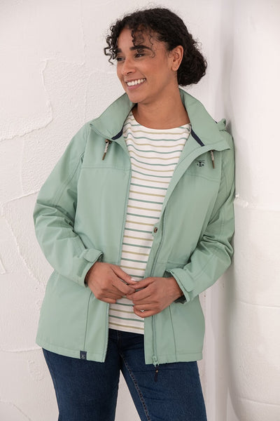 Lighthouse Beachcomber Jacket in Basil- Waterproof and Breathable Polyester Rain Coat with striped lined hood and pockets, on model