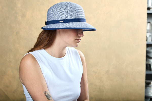 Woman wearing the Annie Cloche hat in the navy mix colour.