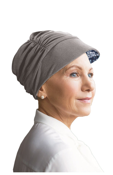 Woman wearing grey reversable tigerlily hat in grey made by Watuko Headgear