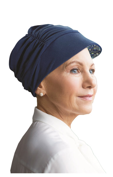 Woman wearing a navy reversable Tigerlily hat by Watuko Headwear