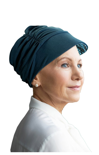 Woman wearing dark Turquoise Tigerlilly reversable hat made by Watuko Headgear CAP 2-207