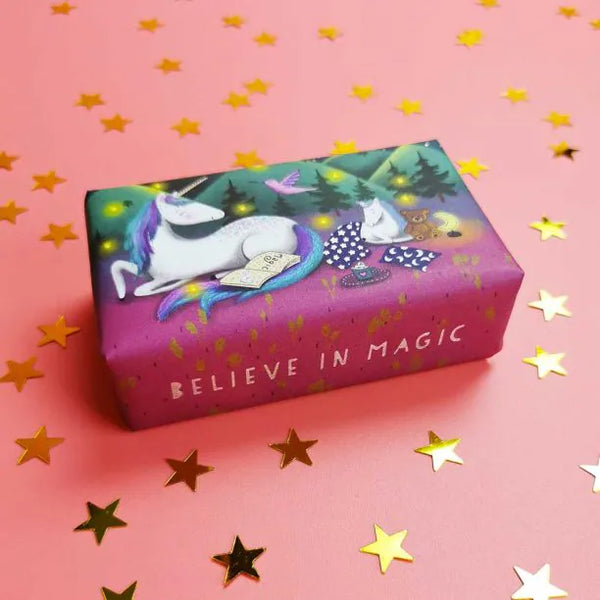 Wonderful Animals Unicorn Soap shown on a pink table with star confetti, and the bottom of the soap bar packaging says "BELIEVE IN MAGIC"
