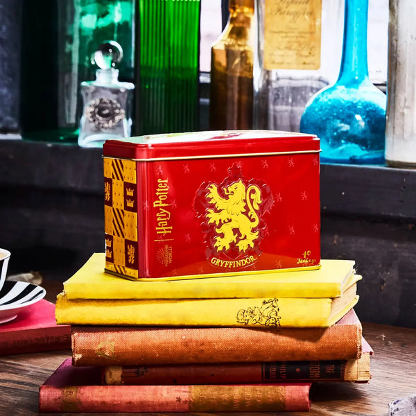 Red tin box with teas inside, which has a Gryffindor logo and Harry Potter branding on the box