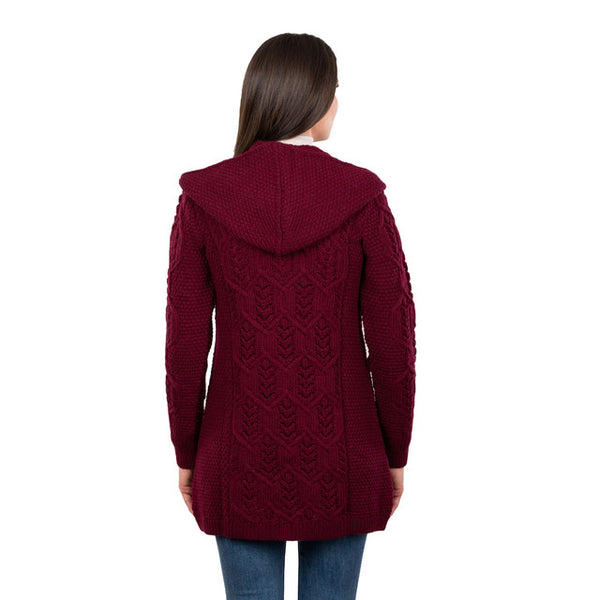 Wine coloured knitted cardigan worn by a person on a white background