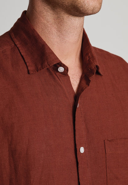 Close-up view of the neckline of a model wearing the Regular Fit Rust Pure Linen Shirt.