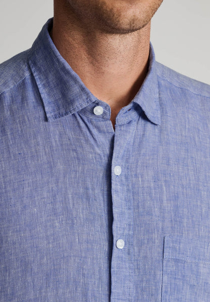 Model wearing a Brook Taverner Linen Shirt 4591H light blue with a close up view of the neck and buttons