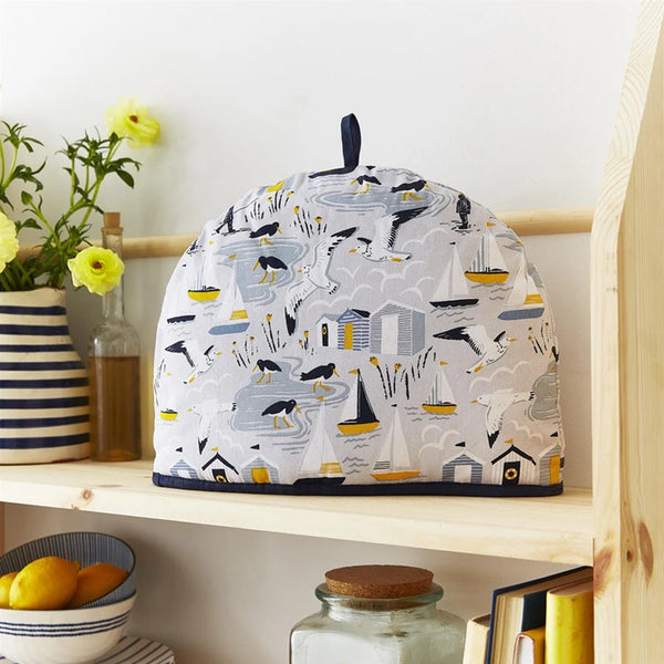 Tea cozy with nautical pattern on a wooden shelf