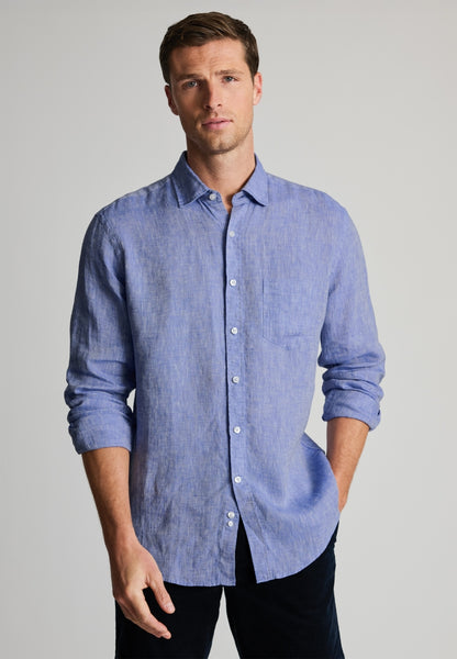 Model wearing a Brook Taverner Light Blue linen shirt with black pants