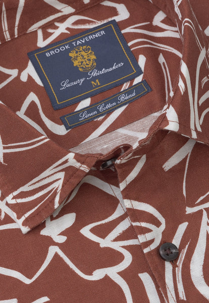 Up close view of the neckline of the rust coloured floral cotton linen short sleeved shirt.