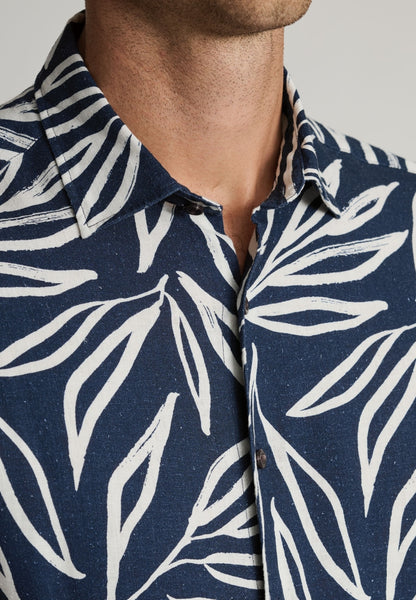 Male model wearing Cotton Linen Navy floral shirt and an up close view of the neckline