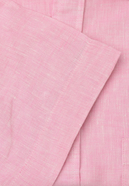 A close-up of light pink textured linen fabric with a folded corner showing the woven material detail.