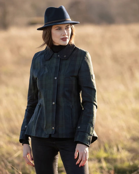 Ladies Oxford Blue washwax Ambre jacket in blackwatch  worn on model with golden field in background.