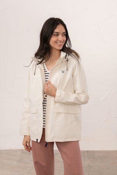 Lighthouse Beachcomber Jacket in Chalk- Waterproof and Breathable Polyester Rain Coat with striped lined hood and pockets, on model