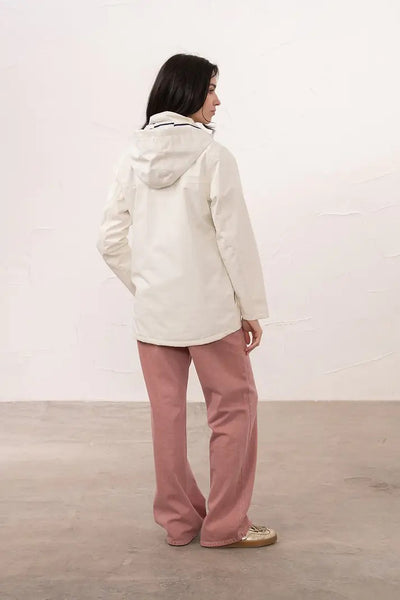 Lighthouse Beachcomber Jacket in Chalk- Waterproof and Breathable Polyester Rain Coat with striped lined hood and pockets, back view of coat on model